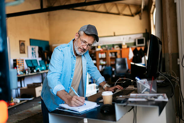 Workshop owner keeping business waste movements documented